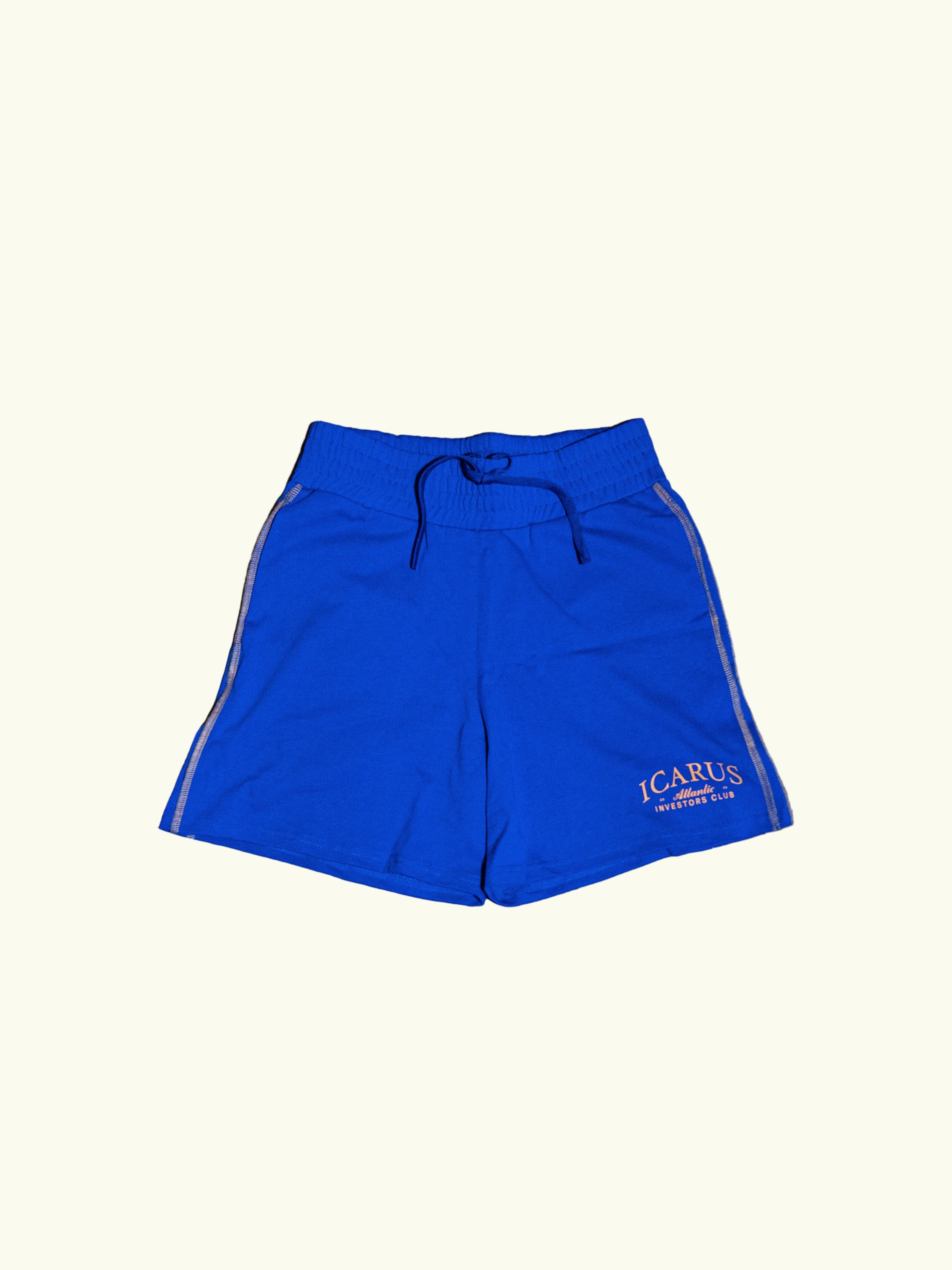Blue shorts with a brand logo on a concrete floor