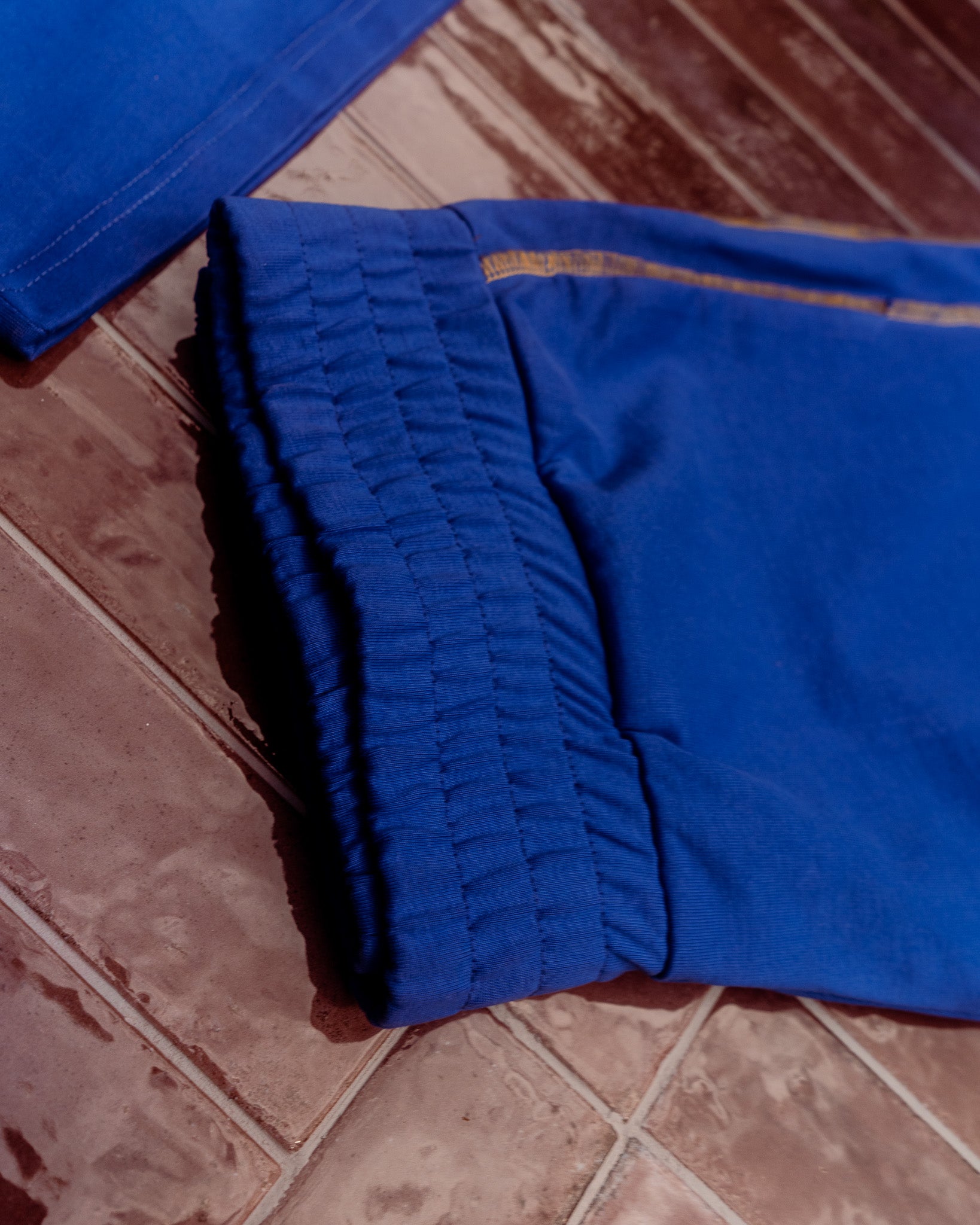 Blue pants on a tiled floor